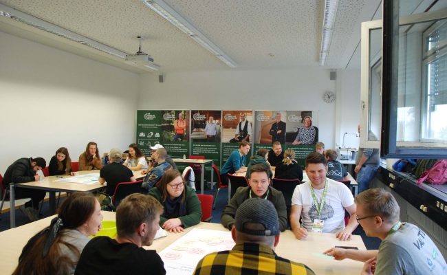 Verschiedene Gruppen arbeiten im "World Café" an verschiedenen Themen